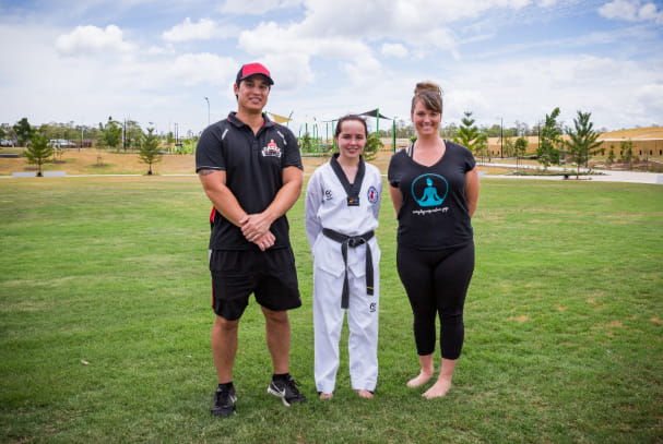 Taekwondo girl with man and woman