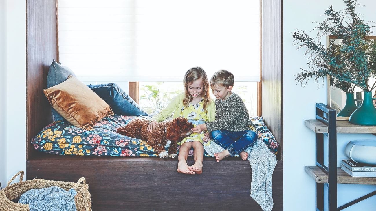 Kids with puppy on bed