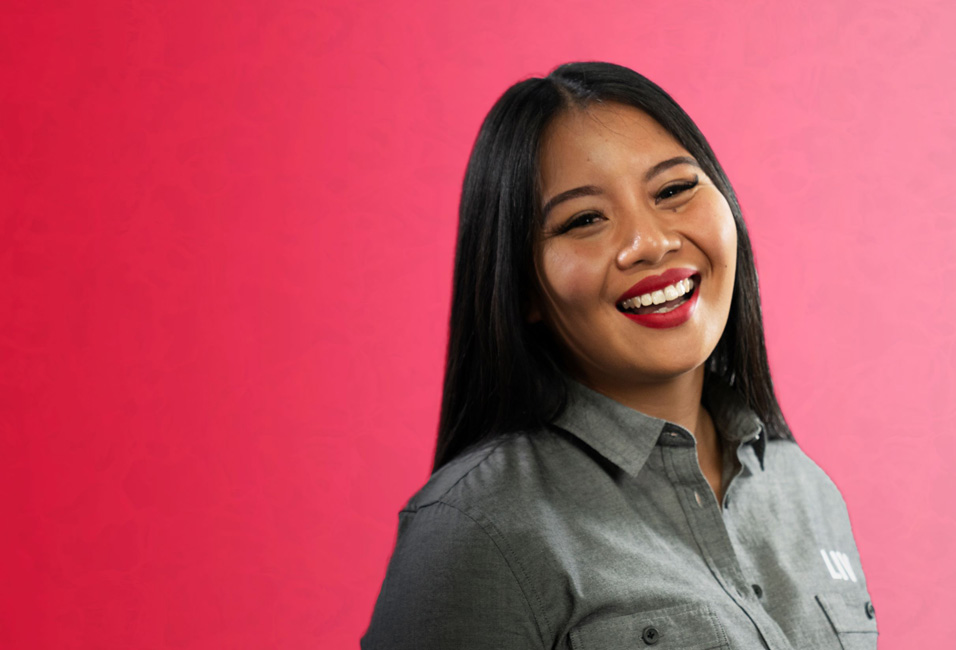 girl on pink background smiling