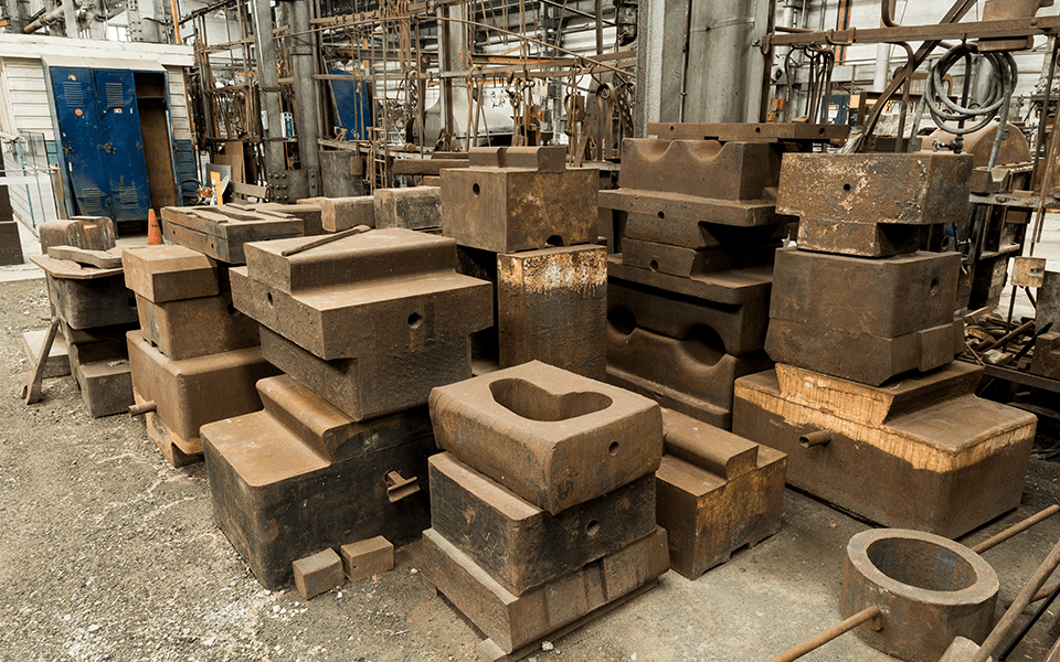A collection of various sizes of swage blocks and dies used on the Davy Press. Some with a dove-tailed head to fit into the crosshead mounting on the Davy Press.