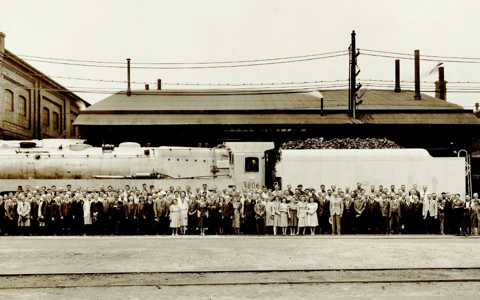 Women in the Eveleigh workforce, 1942. Steam Locomotive C3806 in background.