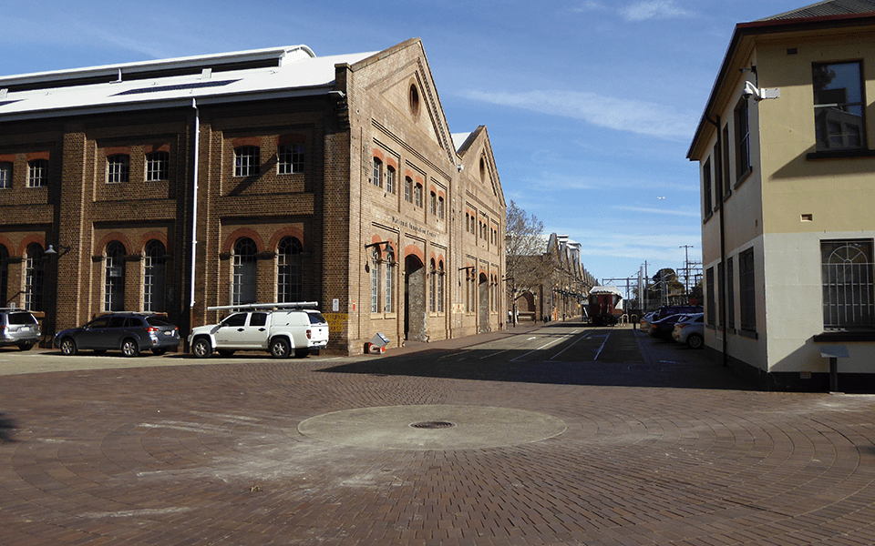 New Loco Shop, now the National Innovation Centre, in 2016 (left). Works Managers Office (now International Business Centre) (right) and Locomotive Workshops visible in background.