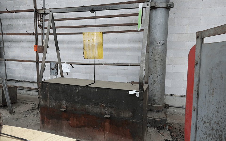 Example of a quenching tank used for tempering or hardening springs, originally sunk into the ground in the Spring Shop. After being formed, springs would have been loaded onto a small steel tray and lowered into tank like this one using a counterweighted cable.  